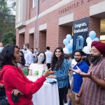 graduates and current students meet with Professor Montek Singh at the Class of 2020 Celebration