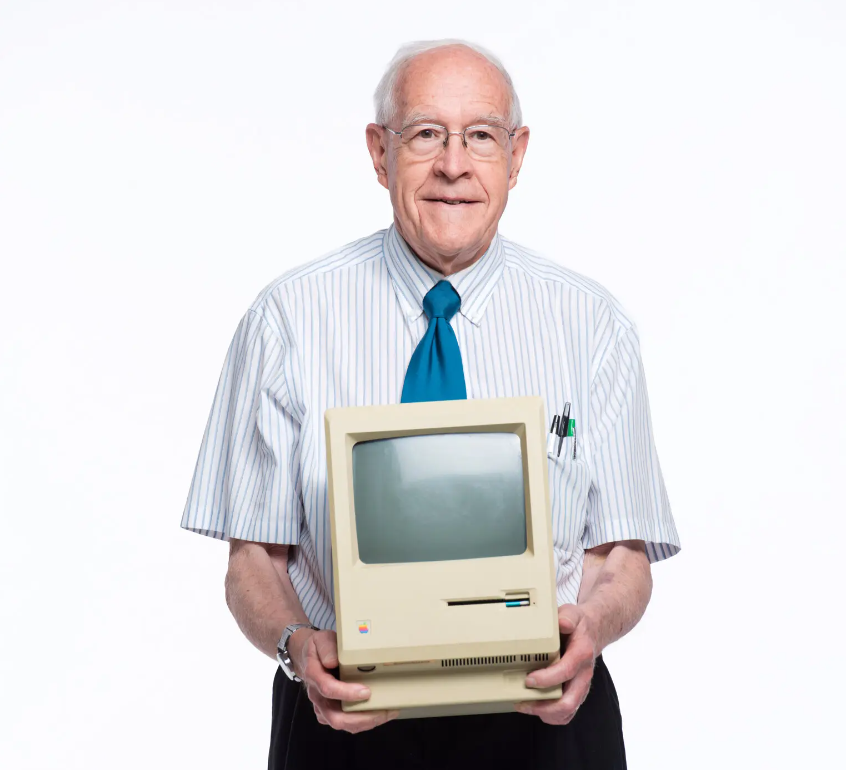 Frederick P. Brooks Jr. in 2014 with a first-generation Apple Macintosh computer