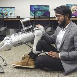 Aniket Bera with a robot aid dog