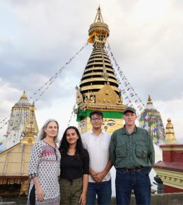 Lauren Leve, Bibhusha Ojha, Bibhor Bista, and Jim Mahaney pose for a photo at Swayambhu.